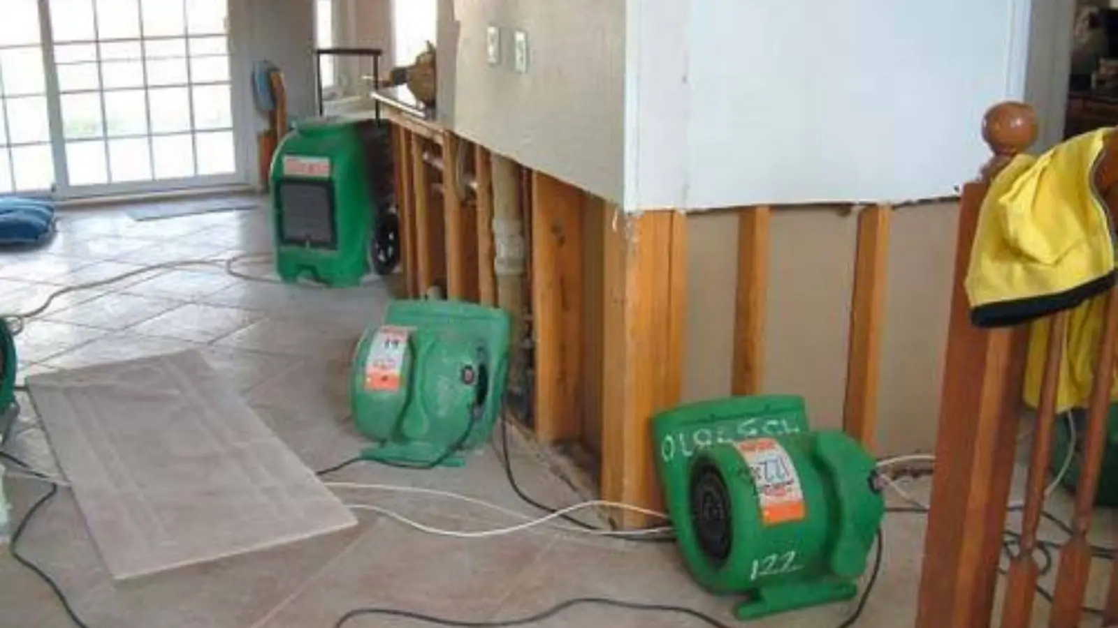 Air movers drying a room after the lower wall was opened up for water damage